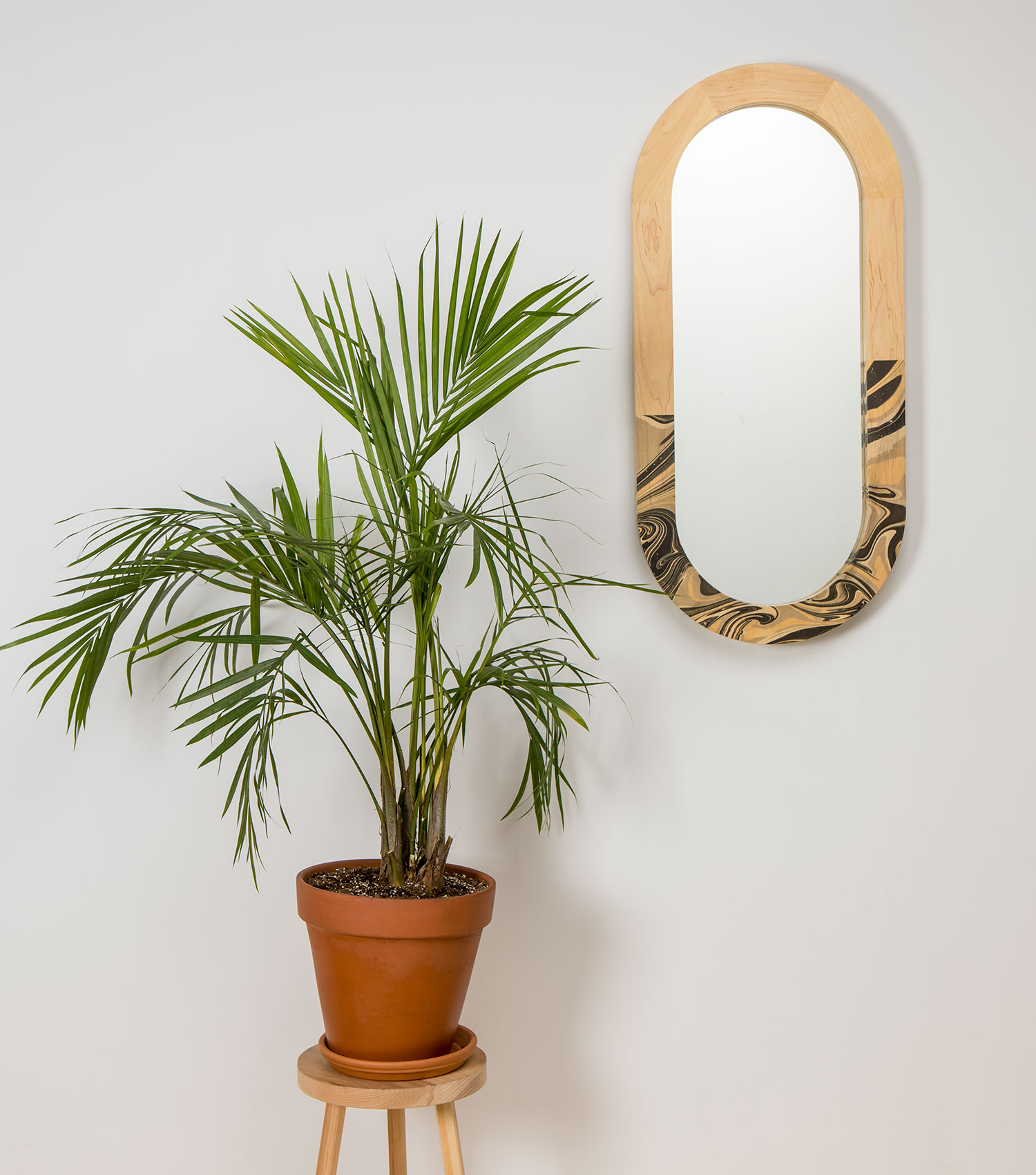 A beautiful wooden oval mirror with a palm tree. On mouseover: a handsome rectangular wooden-framed mirror with a marbled finish.