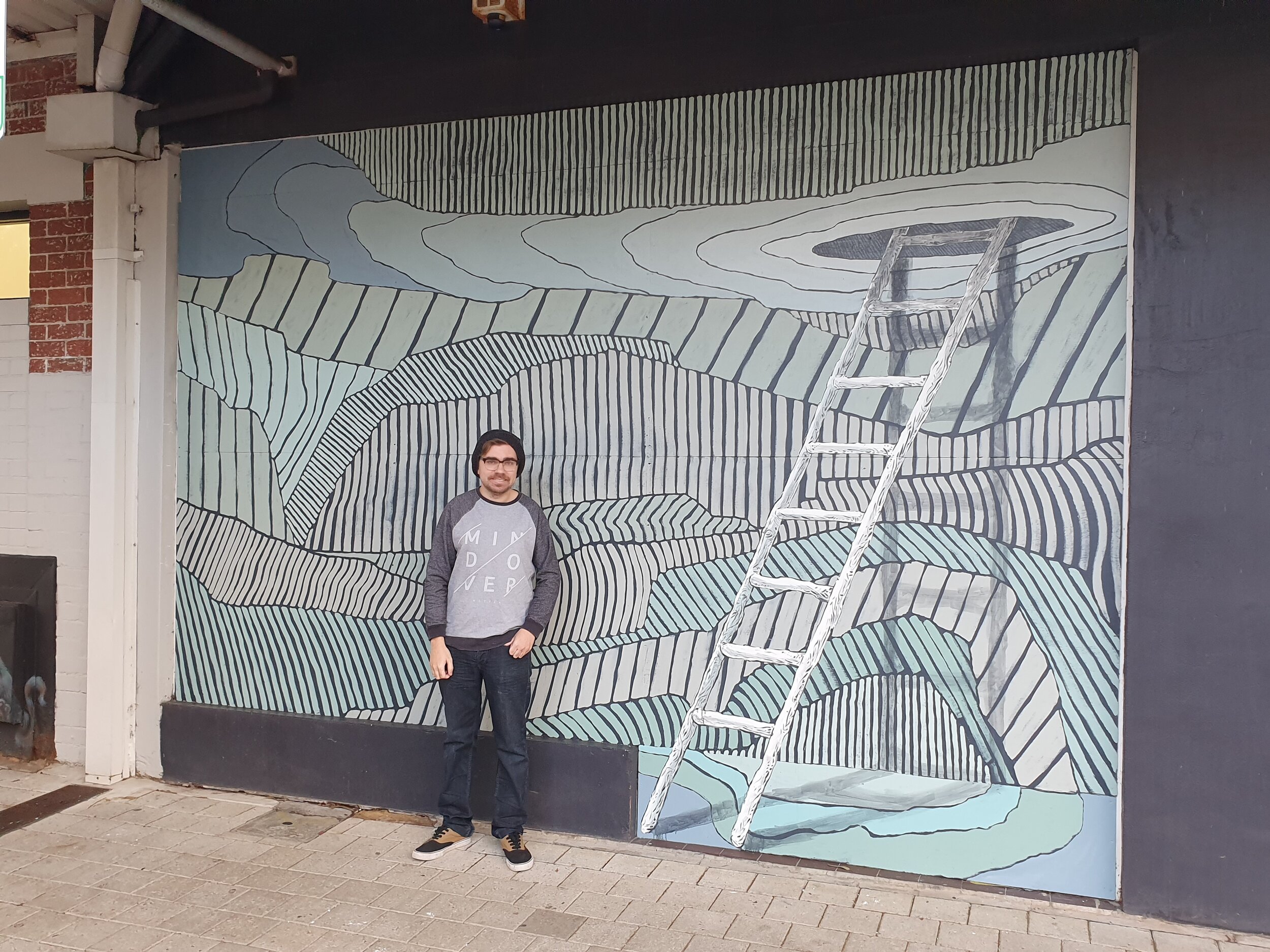 Dylan Nietzreba worked with guidance of his mentor, Andrew Frazer, on a mural in Bunbury