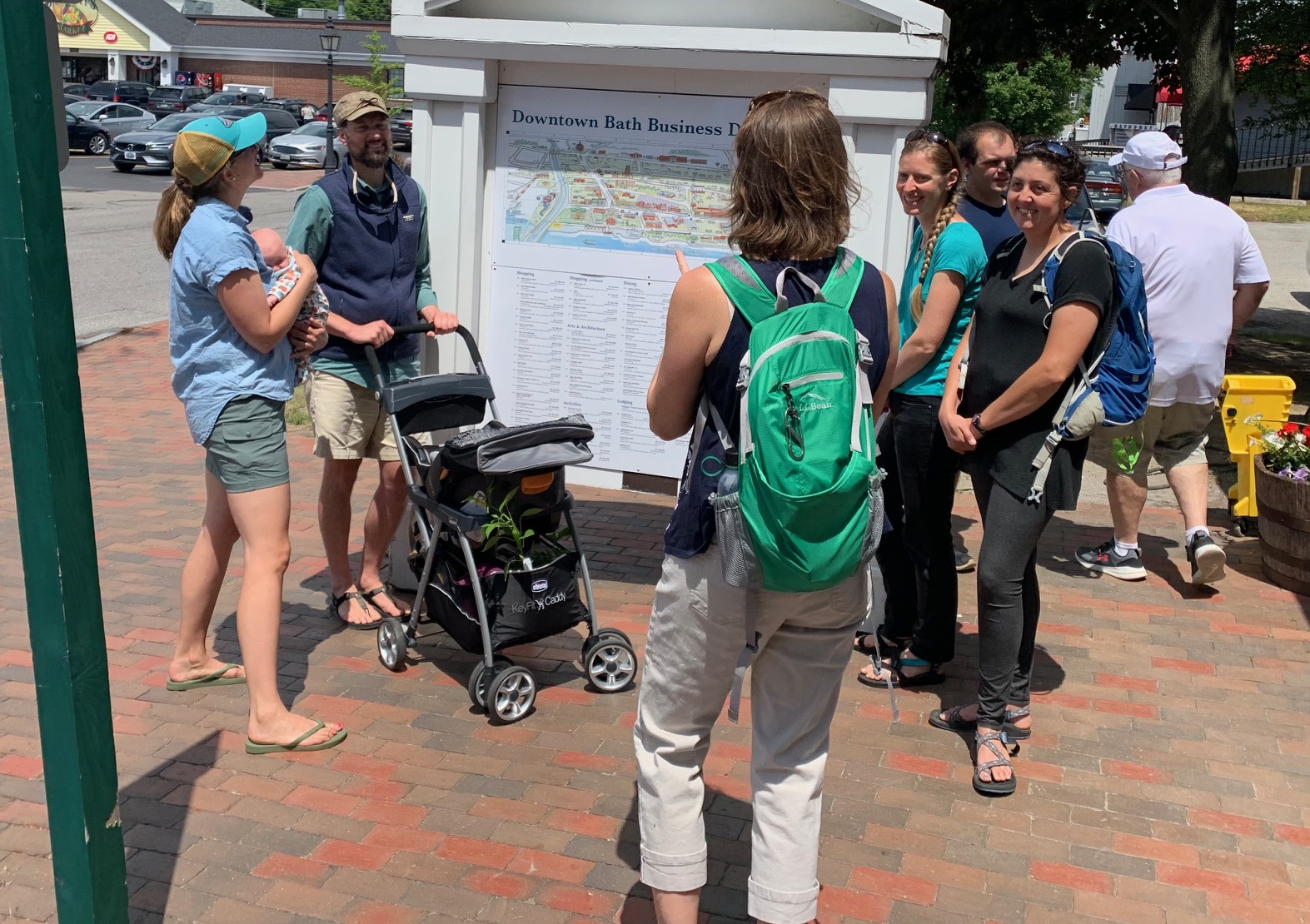 People gathered around a map for a Bath tour