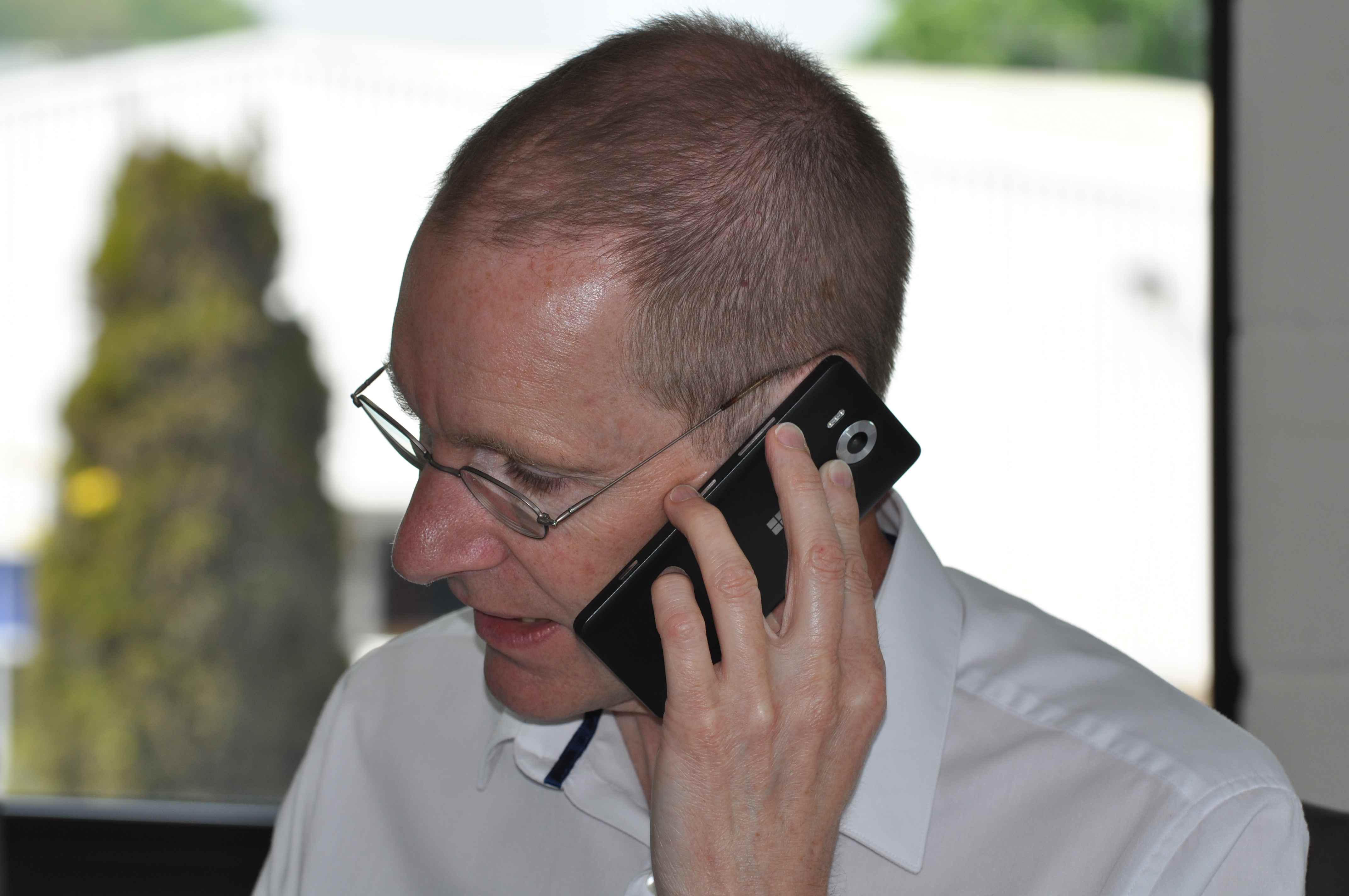 A photo of director, Mike Stephens, taking a phone call