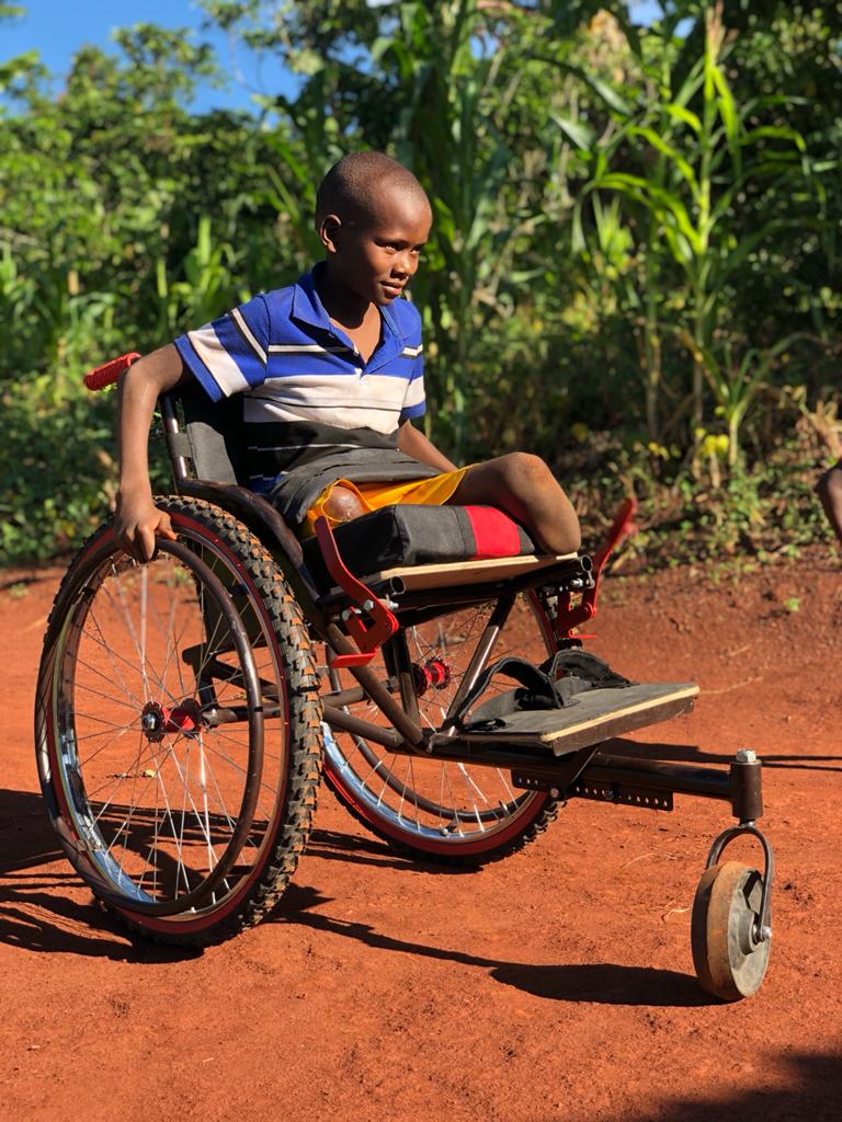 Boy in a Kyaro wheelchair smiling