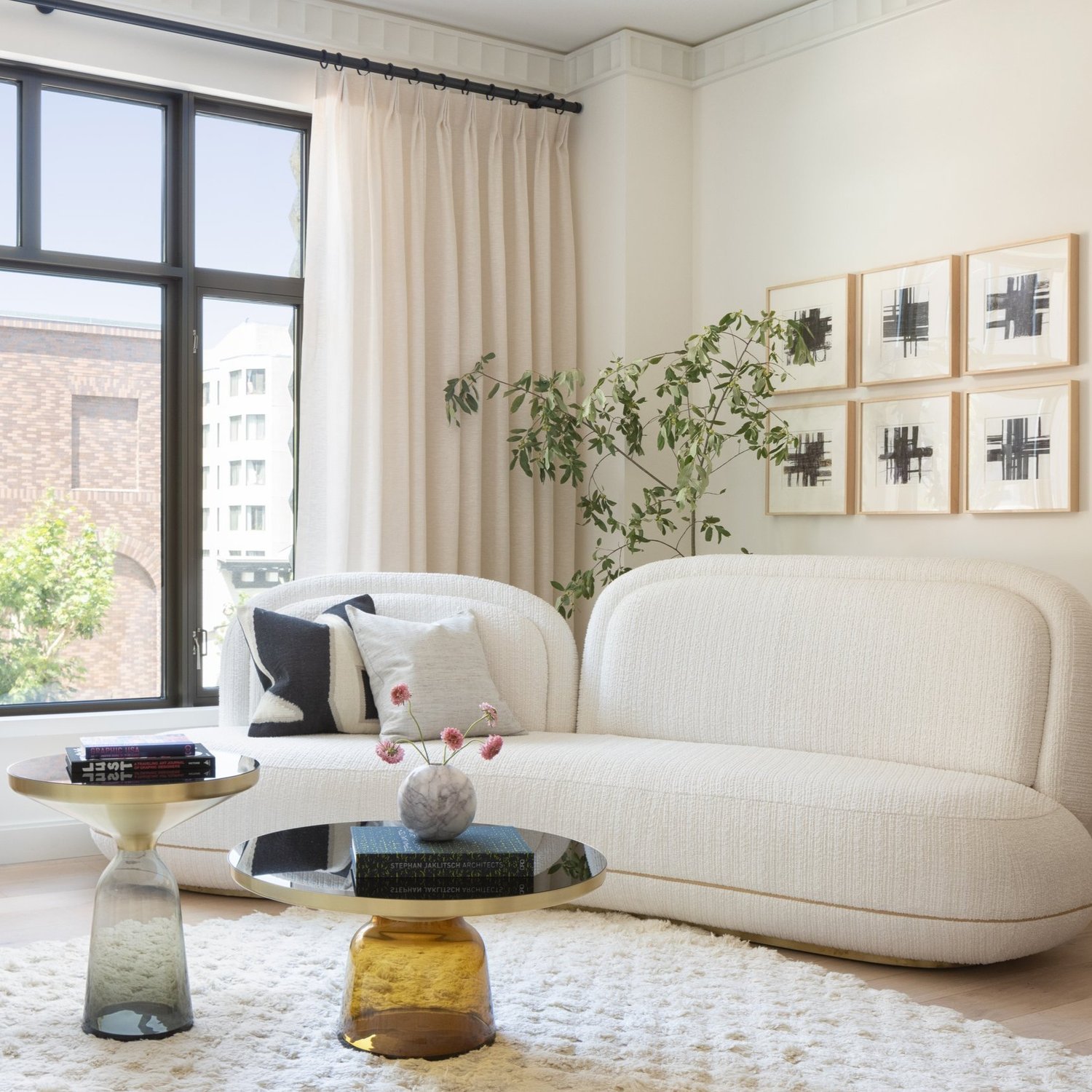 A rendering of a furnished corner living room.