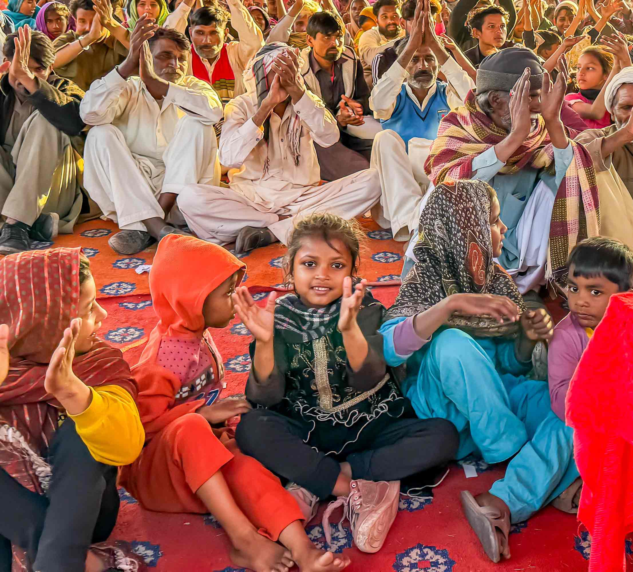 girl with crowd lifting up hands to the Lord