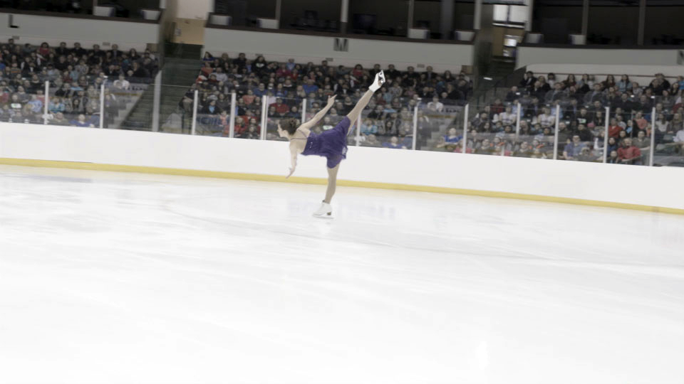 Ice skater in front of a packed crowd in a still from Ice the Movie, with VFX completed by Foxtrot X-Ray