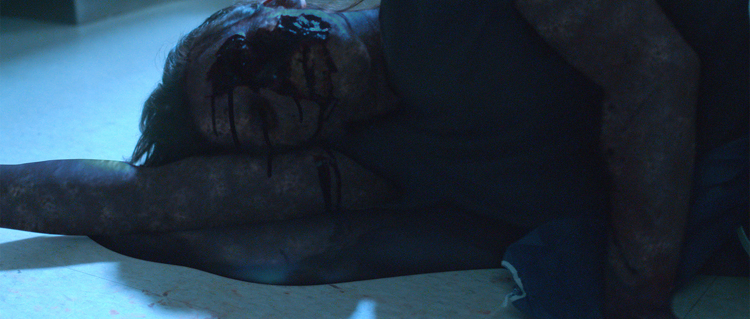 An actress lies on the floor of a lab in the short film Nova, with digital makeup and additional gore added by Foxtrot X-Ray