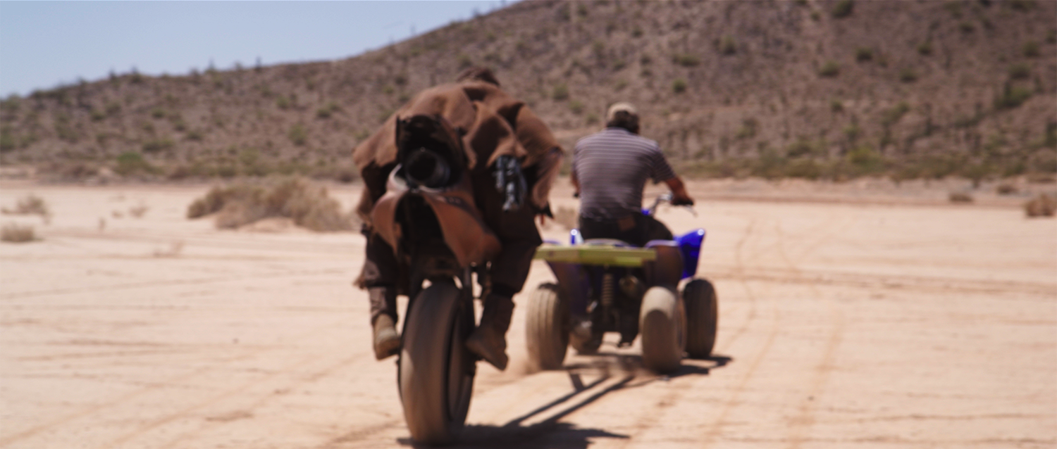 Actor Larry Coulter rides a rocket unibike, towed by an ATV, in the short film Aftermath