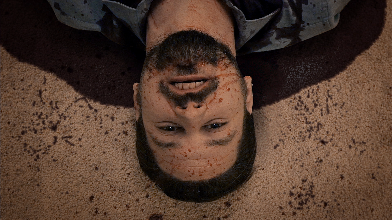 A bloodied actor lies on a carpeted floor in the movie Cruel Hearts, with additional blood VFX completed by Foxtrot X-Ray