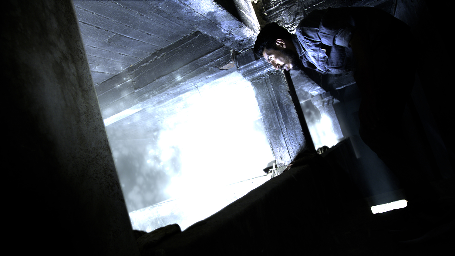 A man stares into a glowing abyss in What is Buried Must Remain, with VFX completed by Foxtrot X-Ray