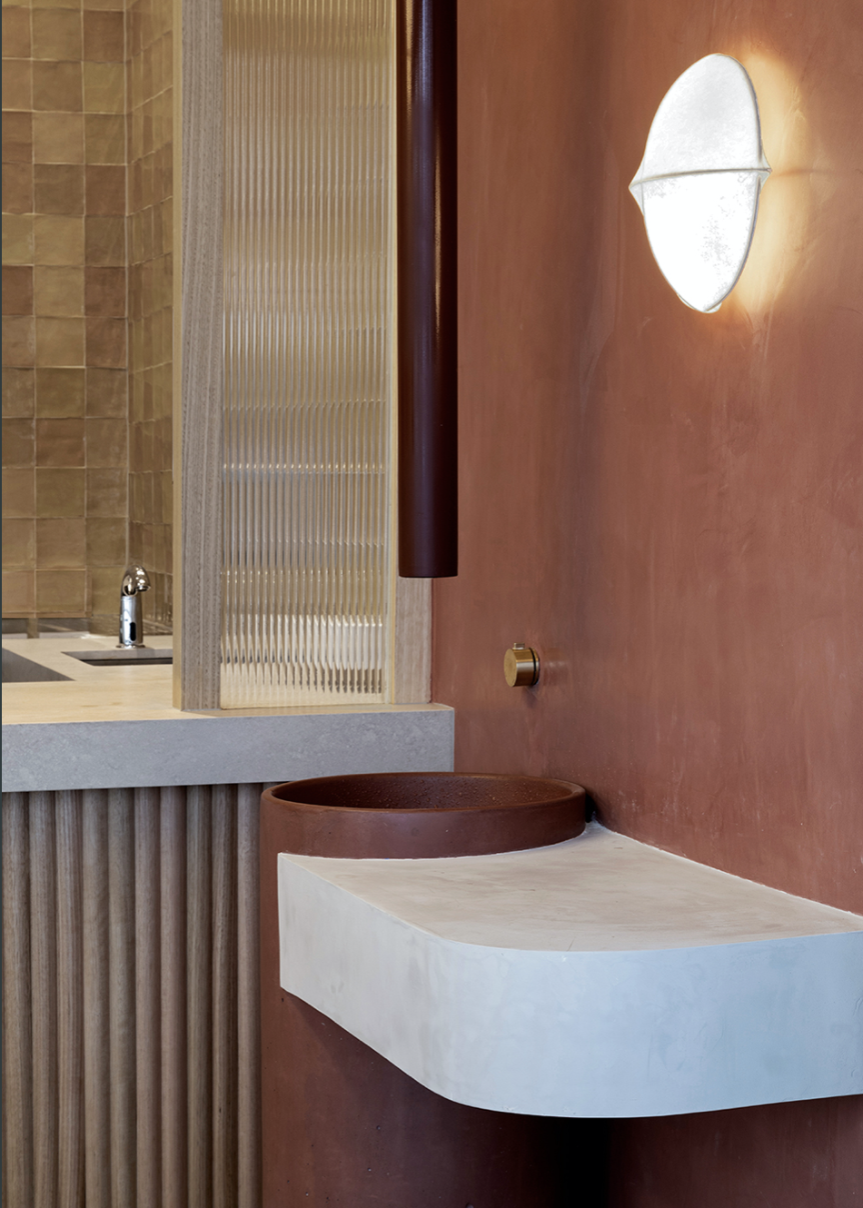 petite salle de bains avec murs et bassin en terracotta