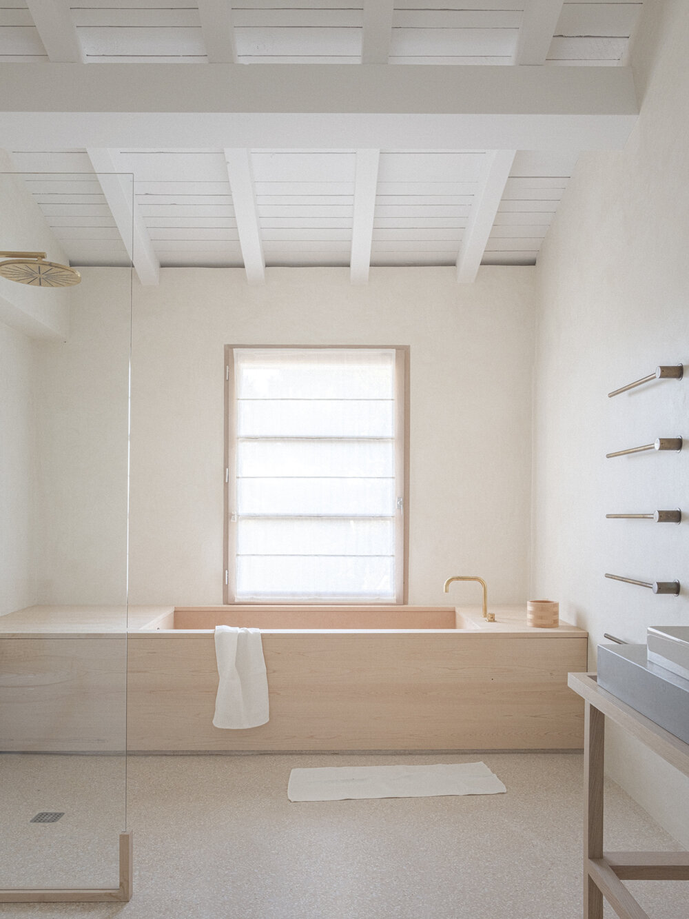 wooden bathtub and terrazzo floor for a minimal bathroom
