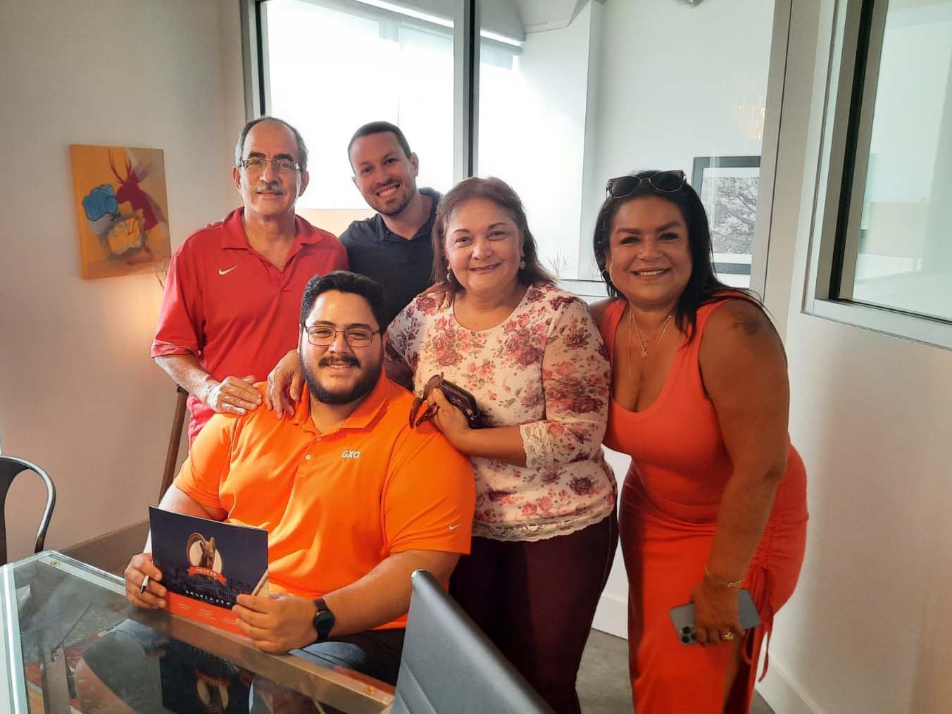 Felix Gil purchased a home using both IDA and DPA match savings funds. This image is of the day he signed, surrounded by his family.