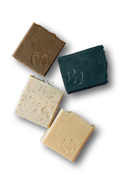 Four handmade soaps are imprinted with a funky letter E icon