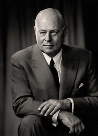 Black and white professional photo of founder E P Taylor wearing suit and tie.