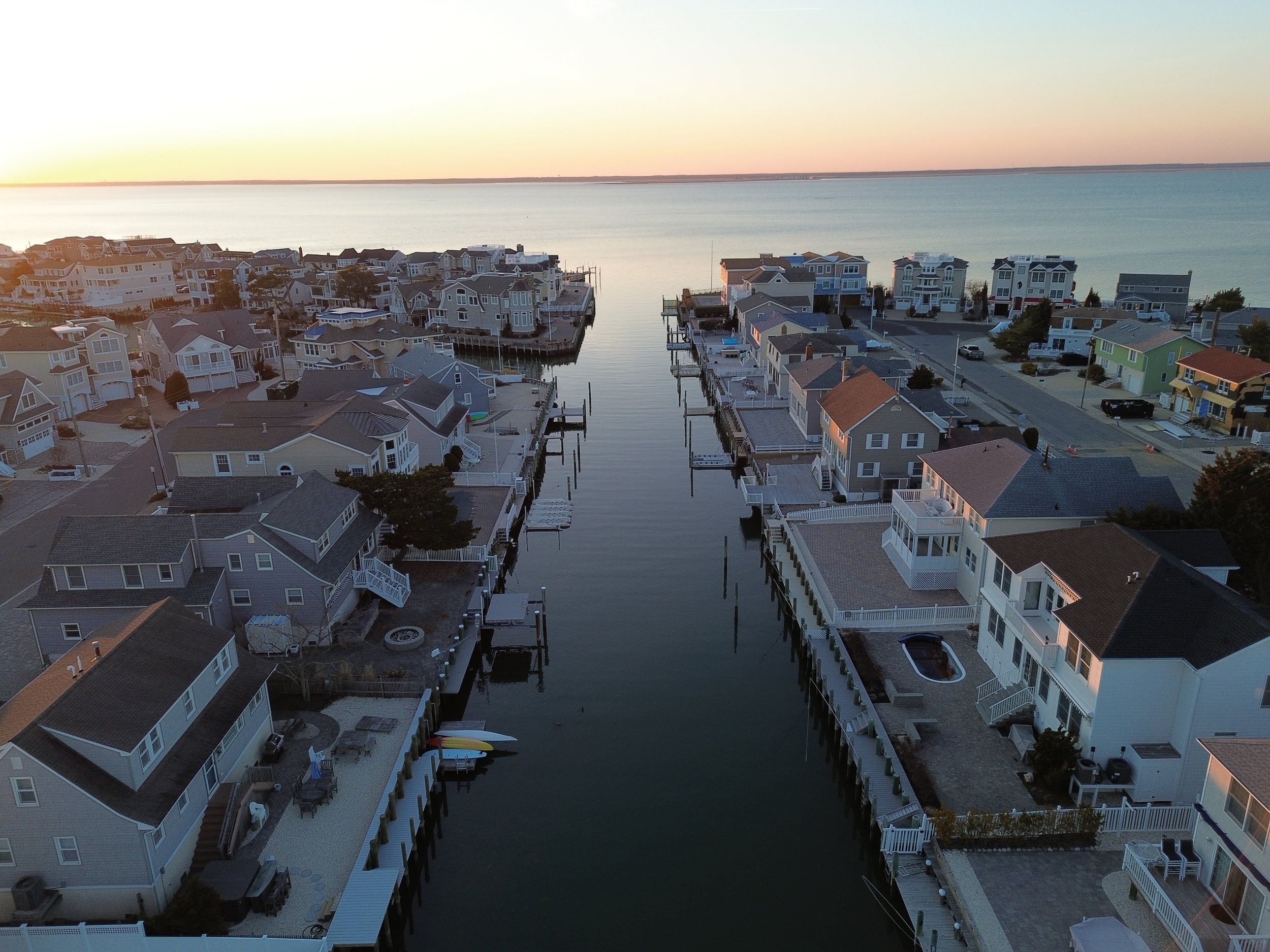Homes on the bay in The Dunes neighborhood of Long Beach Island at sunset.