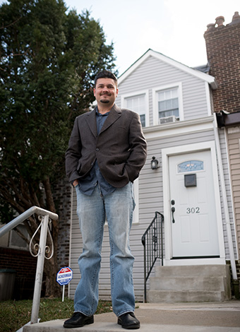 man in front of home