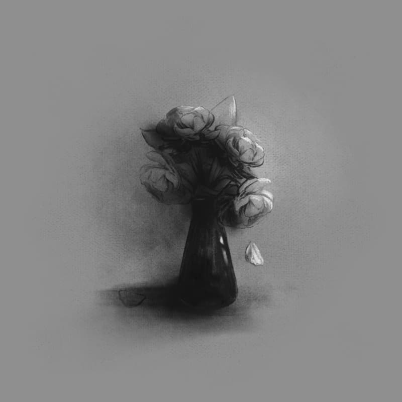 A petal falls from a vase of flowers on the bedside table.