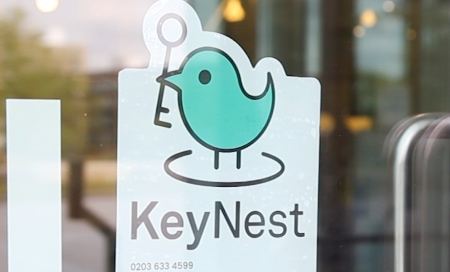 KeyNest sticker on a window of a local store