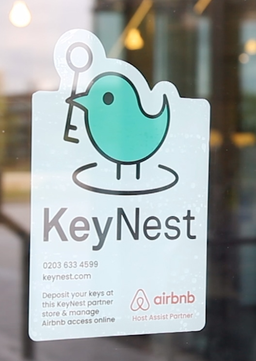 KeyNest sticker on a window of a local store