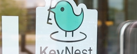 KeyNest sticker on a window of a local store