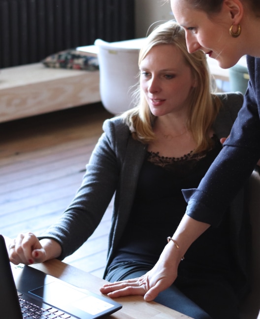 Two letting agents viewing KeyNest portal on the laptop