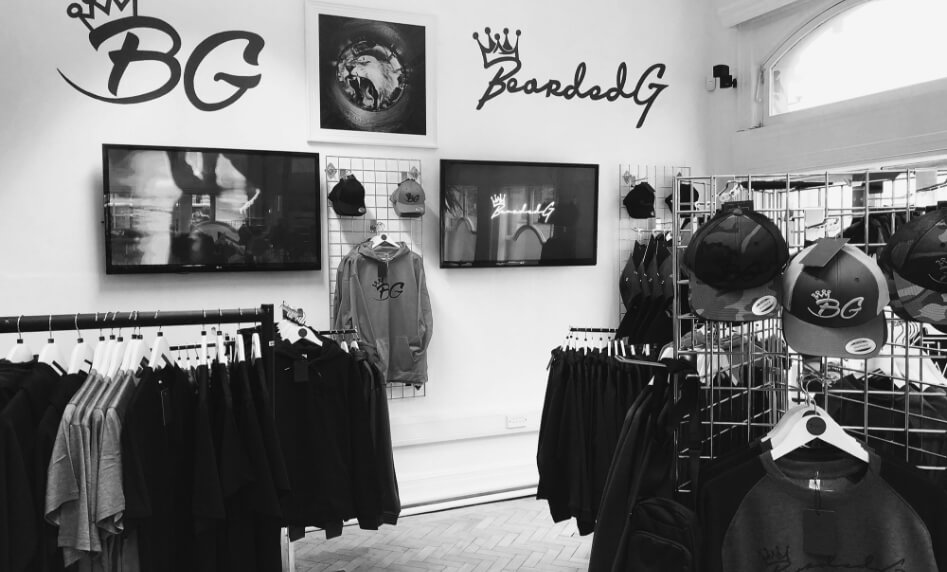 Interior of the store featuring a mirror and a wall painted as the background of an identity parade.