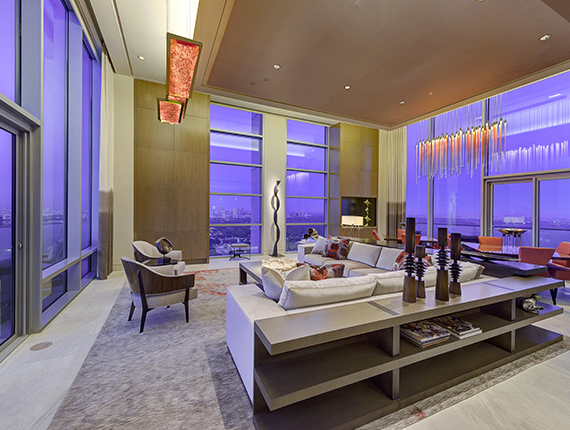 Modern high rise living room features large windows to take in the Houston, Texas skyline.